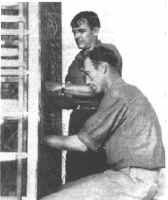 ndiana Bell Splicers, Charles Petraits (left) and Leo Becker, at work on the frame in Camp Atterbury Central Office.