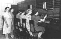 At the Camp Atterbury switchboard, l-r: Chief Operator Frances White, Dolores Witham, Mary Arkins, Jean Michael, Arolyn, and Ada Dugan.  Other operators now on duty at the Camp who could not be present for th picture are Cara Louise Weber, Helen Wachstetter, Jean Simon, Betty Jean Cade, Rita Walker, and Beatrice England.