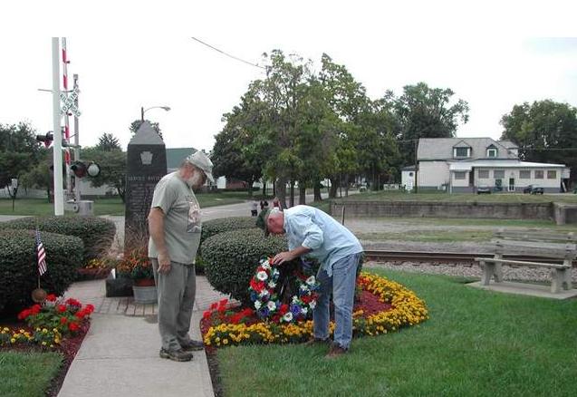 Ed Chapdelaine and Marty Glazier, right, place a wreath at the memorial dedicated to 33 Pennsylvania National Guardsman who died when the train carrying them was hit by a passenger train on Sept. 11, 1950, just east of the village of West Lafayette.