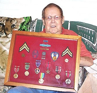<b>MCH Photo | SARA HURST</b><br>Ben Almendinger shows the framed case holding his numerous medals from his service in World War II. One of his Purple Hearts and his Bronze Star are in the center of the display.