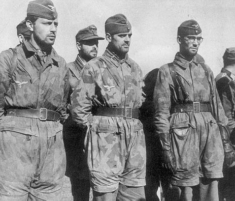 Left: German paratroopers wore special uniforms--including camouflage jump smocks and Luftwaffe eagle insignias--that distinguished them from regular Wehrmacht troops. 48n1.jpg