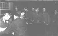 Soldiers placing calls with attendants at the counter in the telephone room.  The soldier with glasses on leaning on end of counter is Corp. C. K. Trippet, son of the secretary of the Princeton Telephone Company, Princeton, Ind.
