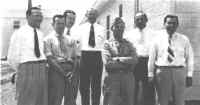 On the job supervisors, l-r: Henry B. Dezelan, commercial representative; Virgil Wallick, Edinburg wire chief; Ivan Barnett, Columbus switchman; Henry Rigor, Columbus plant chief; 1st Lt. Taylor Smith, signal officer; Carl F. Riensche, district construction supervisor, and C. N. Smith, traffic methods supervisor